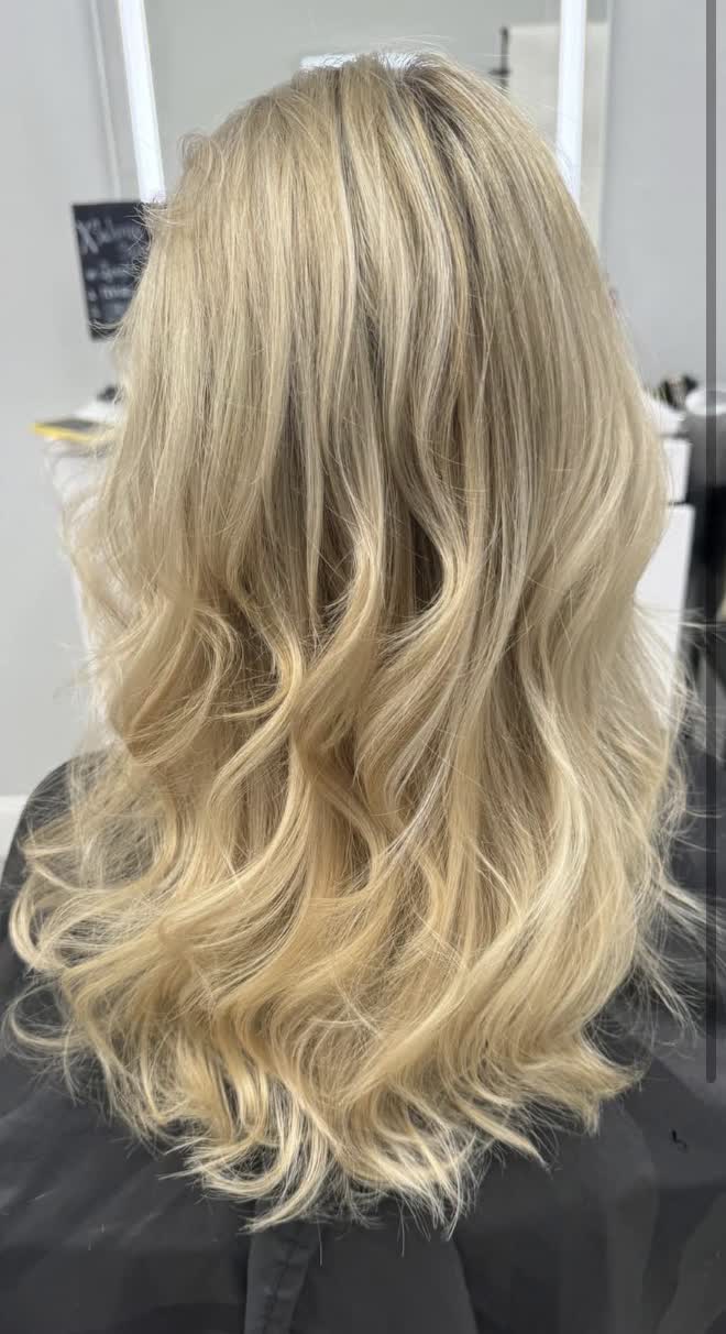 Grown-out highlights refreshed to full bright blonde waves