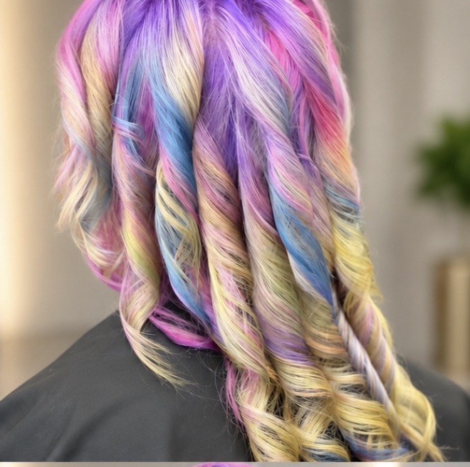 Pastel rainbow underlayer revealed through curls — pink, lavender, blue, and yellow